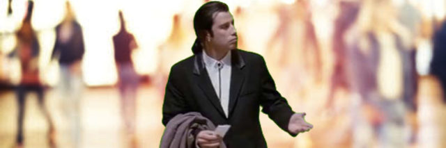 John Travolta meme in front of a filtered blur abstract people background, unrecognizable silhouettes of people walking on a street