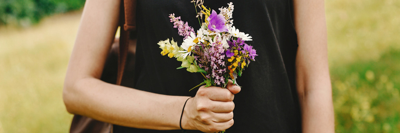 I'm Not Ashamed of Self-Harming and Cutting A woman holding flowers