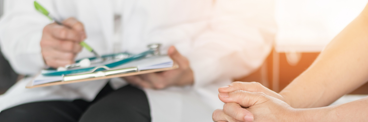 Medical Gaslighting and Undiagnosed Chronic Illness Doctor examining female patient.