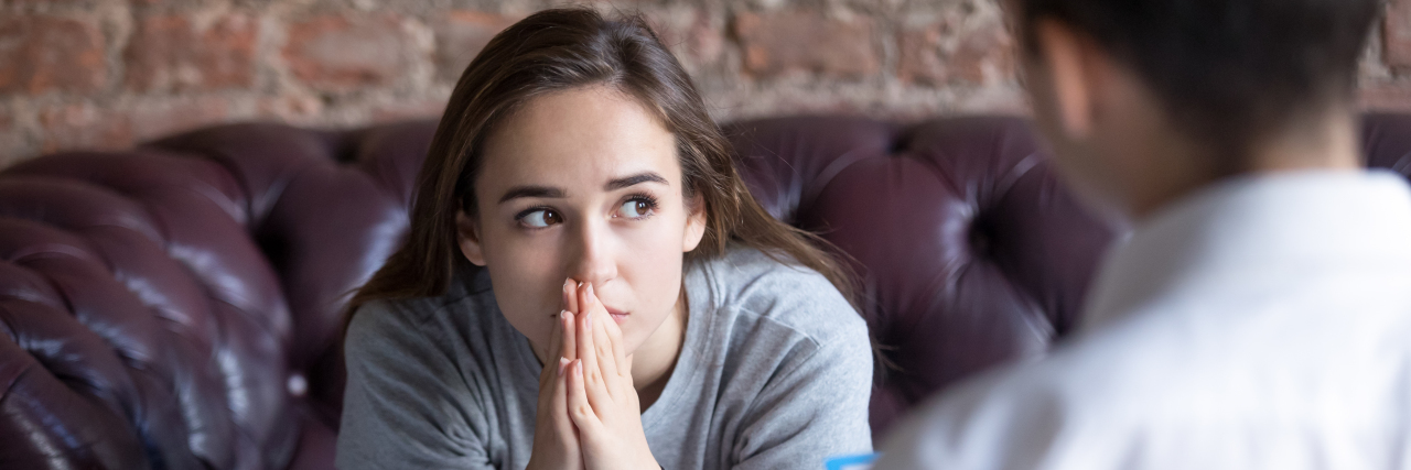 Feeling 'Broken' Because of Chronic Pain young woman, worried, sitting across a doctor