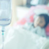patient on bed at saline solution at hospital blurry background