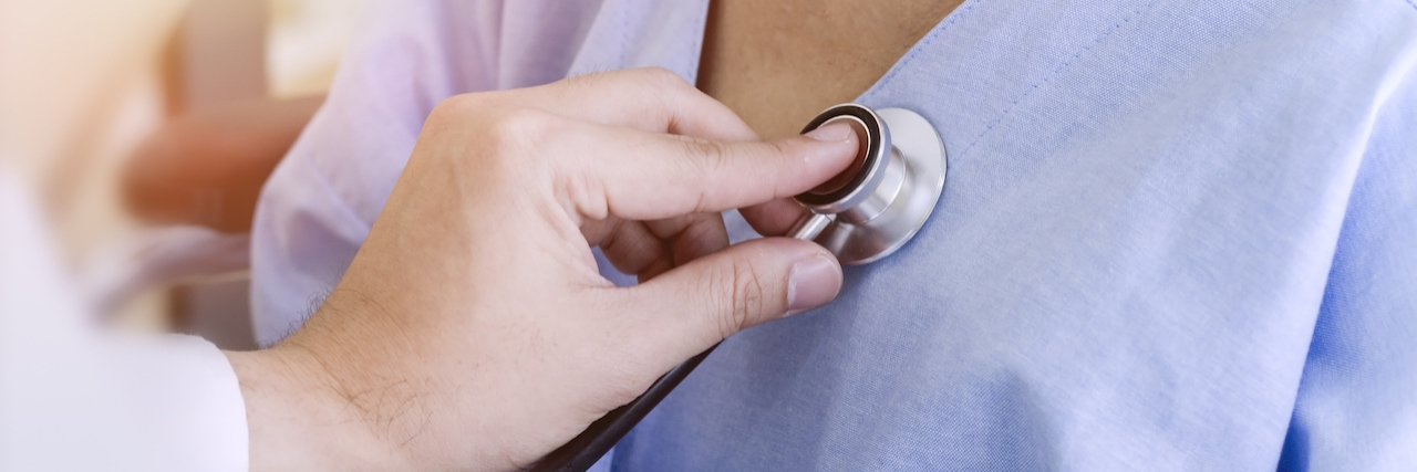 Why It's Dangerous When Doctors Don't Listen to Patients Doctor checking patient's heart with stethoscope at a hospital