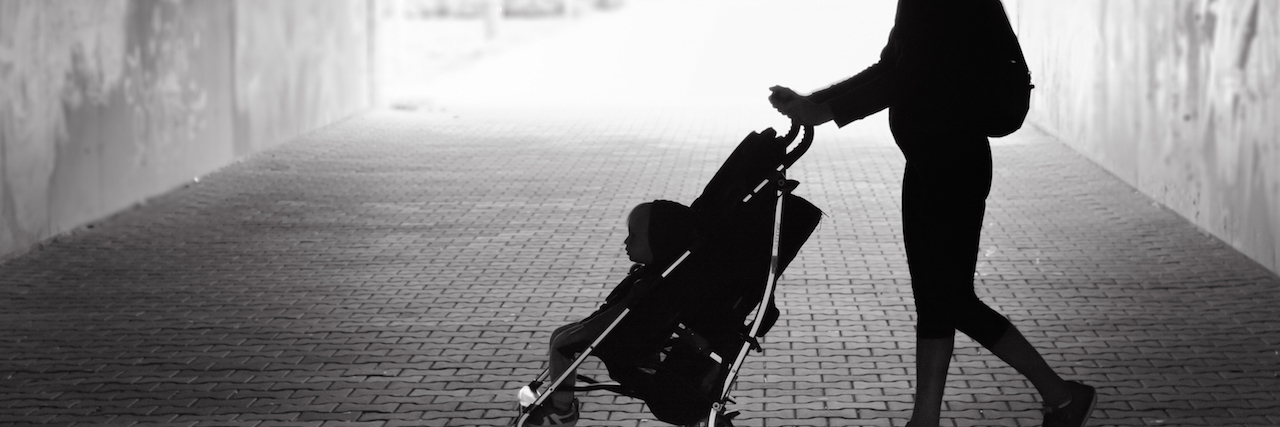 Having a Baby When You Have a History of Psychosis A woman walking her baby in a stroller