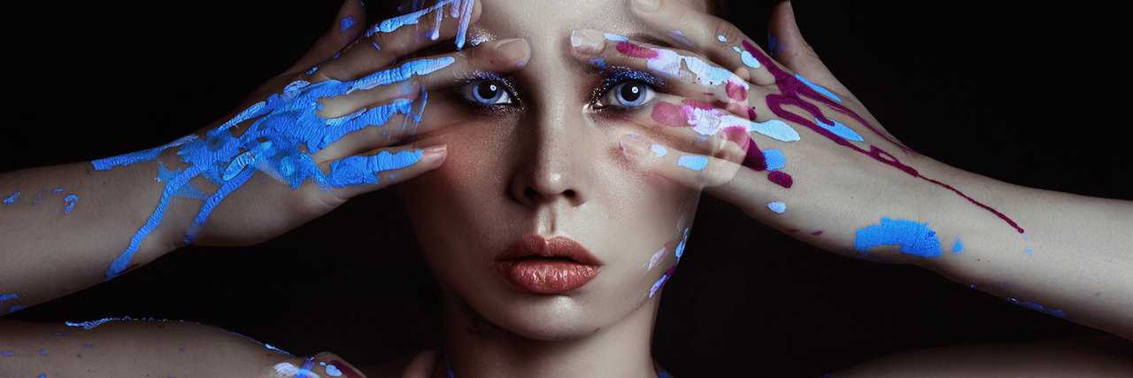 Labeled as 'High-Functioning' When You Have a Mental Illness A woman with paint on her hands, covering her face