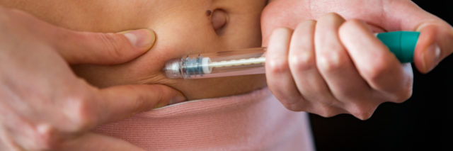 a woman is making on a hormone injection on her stomach