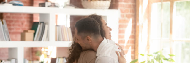 a man and a woman embracing at a support group.