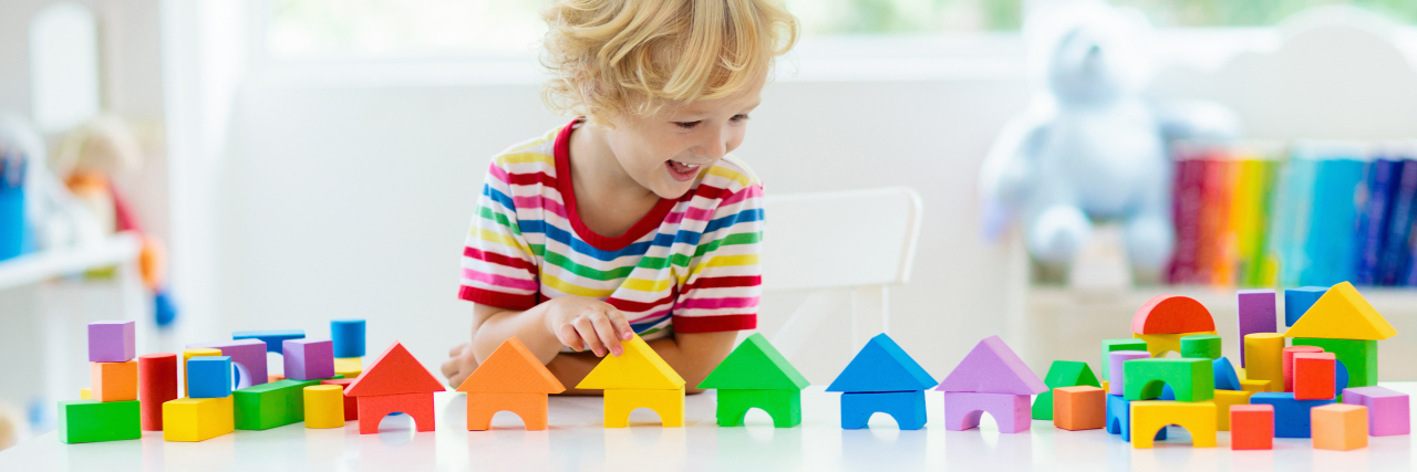 Boy lining up blocks.