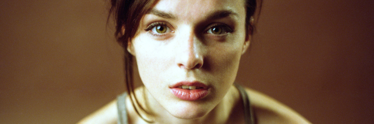 Why the Term 'Fibro Warrior' Doesn't Resonate With Me A woman sitting starting forward