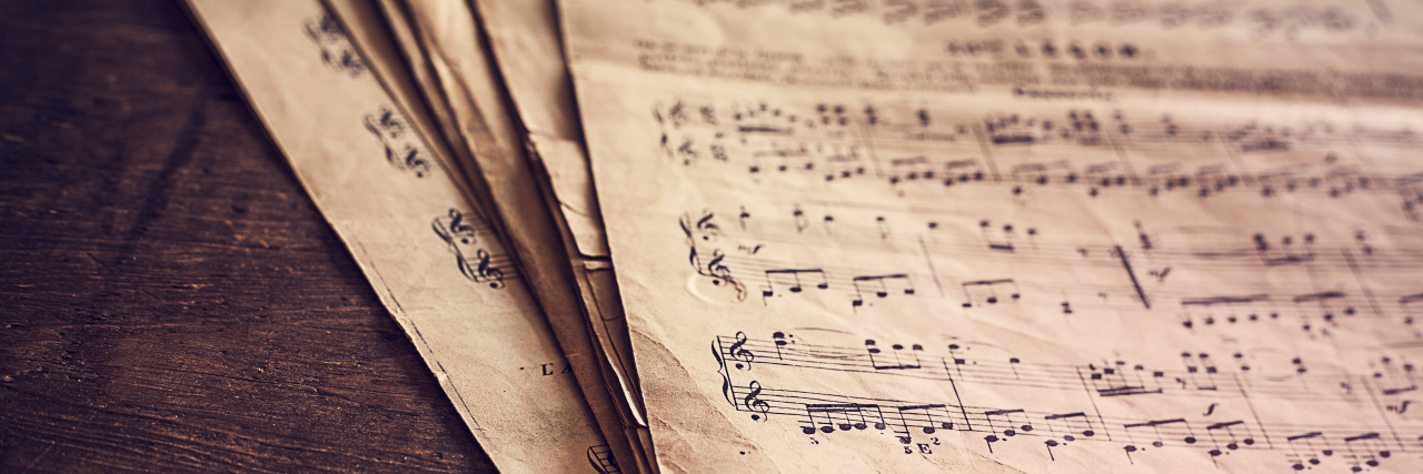 Sheet music on wooden background.