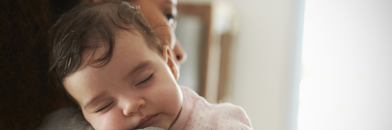 What Not to Say to Caregivers, Parents of Kids With Complex Diseases Close Up Of Mother Cuddling Sleeping Baby Daughter At Home