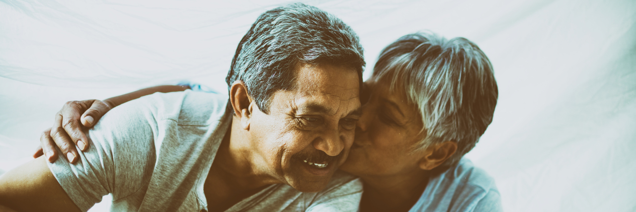 Sex and Ehlers-Danlos Syndrome Older couple cuddling in bed together.