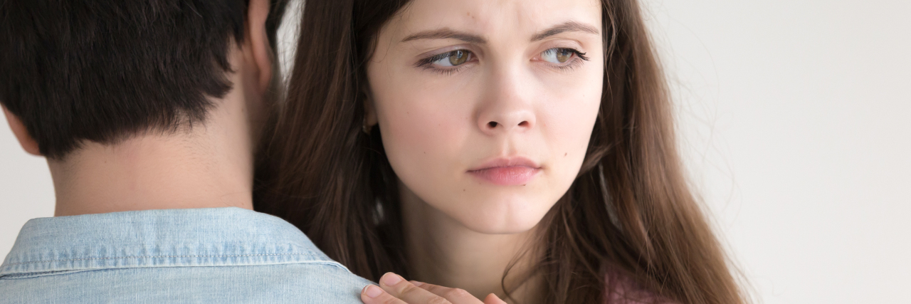 I Trust You, But My Anxiety Doesn't a woman is hugging a man with a sad look on her face