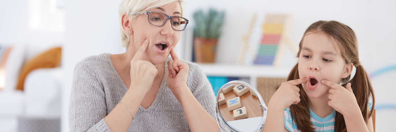 Supporting Children With Apraxia of Speech Speech therapist working with girl.