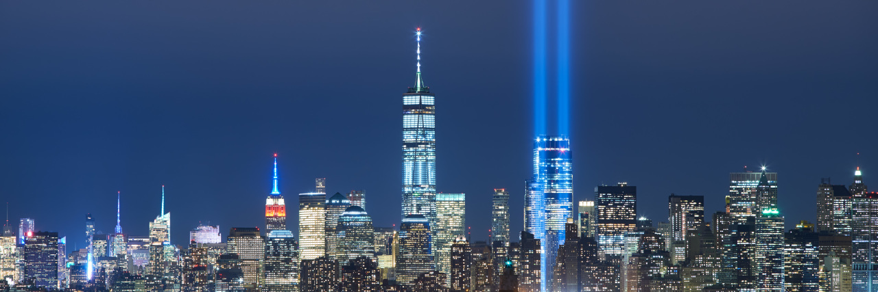 Growing Up With a Limb Amputation and Phantom Pain The two beams of the Tribute in Light with skycrapers of Lower Manhattan at night from New York Harbor. Financial District, New York City