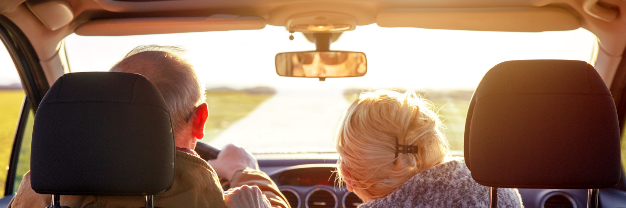 What I Learned After Helping My Aging Parents Agree to Stop Driving Rear view of smiling elderly couple driving car.