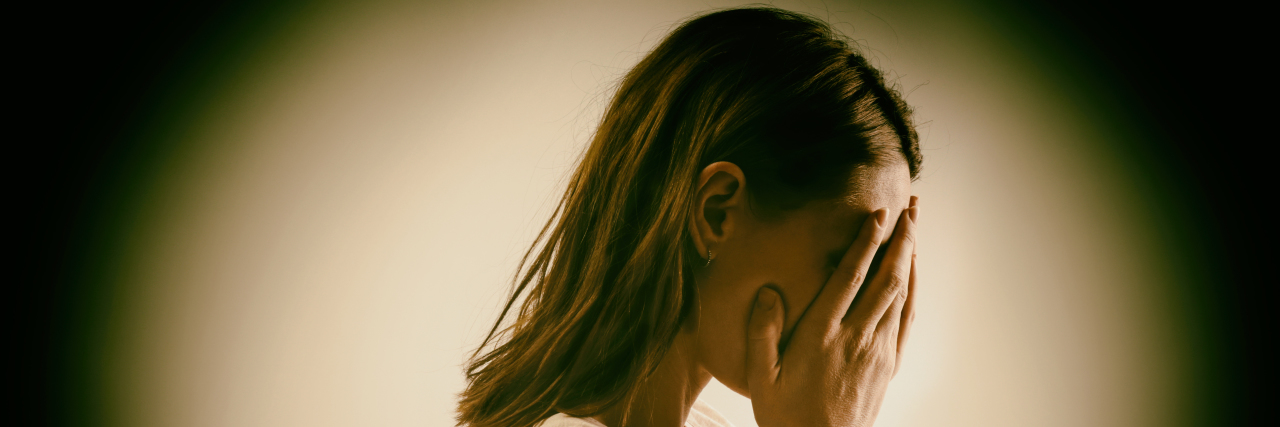 How I Feel After an Autism Meltdown Woman covering her face with her hands.