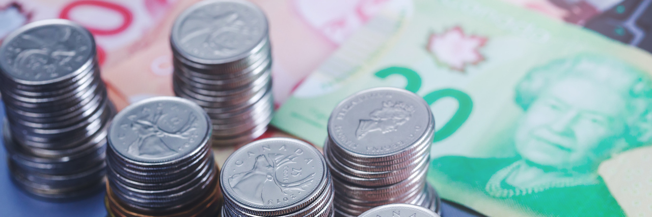 How Much It Costs to Have a Mental Illness In Canada Canadian dollars and coins stacked up