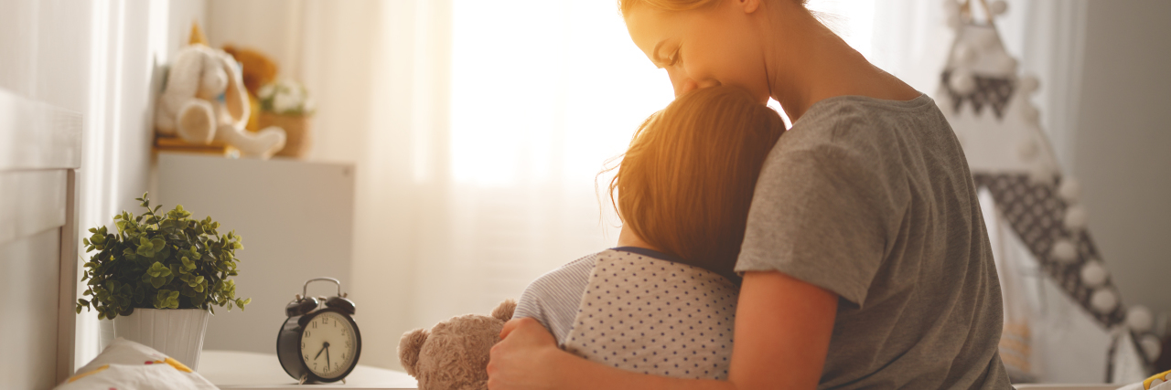 Helping Children Cope With a Parent's Brain Injury Mother and daughter cuddling in morning sun.