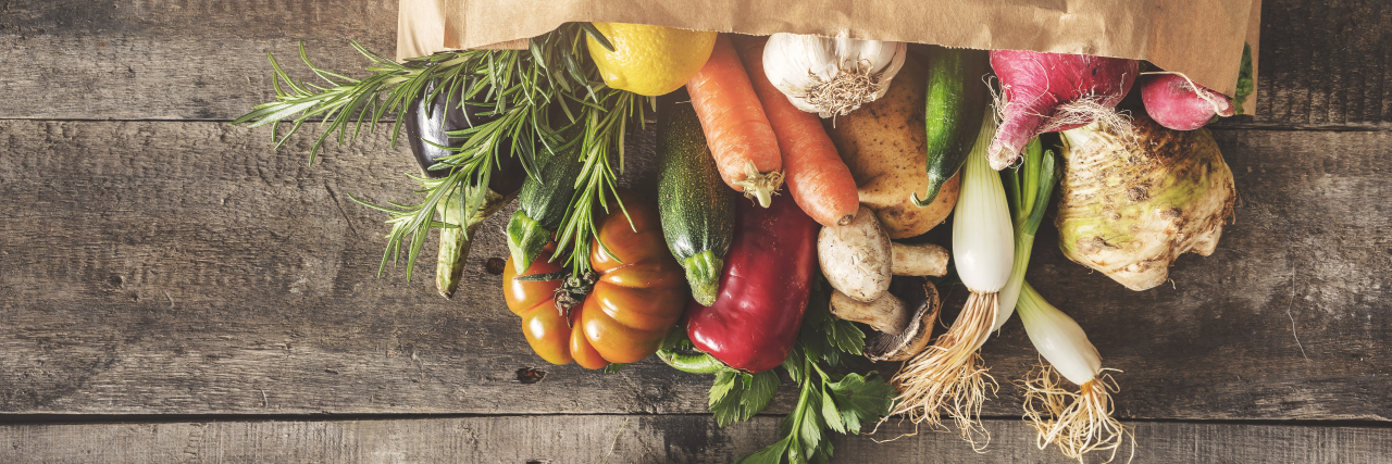 Fresh vegetables in grocery bag.
