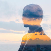 Double exposure of woman face and sunset glow.