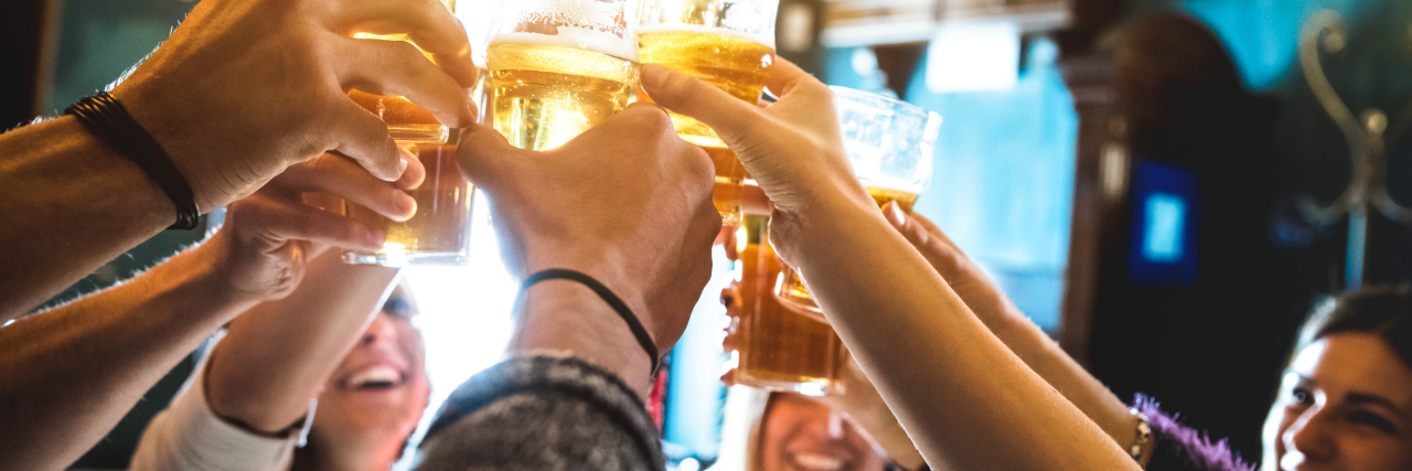 Tips for Partying and Drinking With Anaphylaxis group of friends raising several glasses of beer in a toast