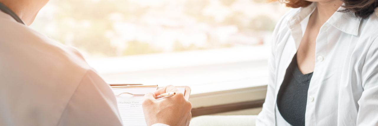 Things My Anxious Mind Tells Me When I Have a Doctor's Appointment woman sitting talking to a doctor