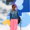 Kim, African-American young woman standing with a cane.