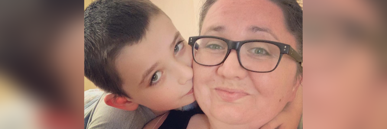 My Child on the Spectrum is 'Ausome' Selfie of son kissing his mom.