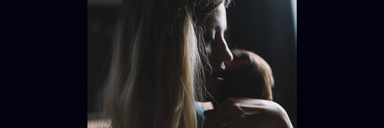 What It's Like to Be Suicidal When You're a Mother A woman holding her child