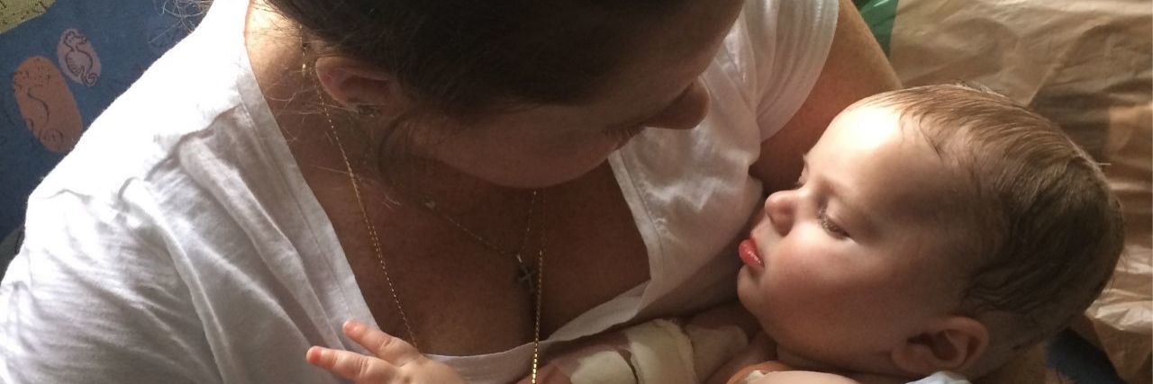 My Advice for Other Moms of Kids With Brain Tumors mom holding baby