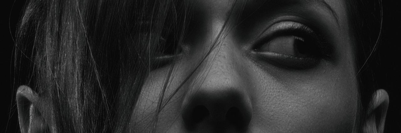 PTSD: Negative Experience Using Marijuana black and white photo of young woman close up looking out of corner of her eye
