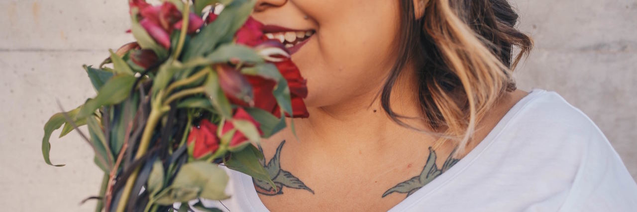 Self-Care Tips for People With Bipolar Disorder A woman smelling a flower