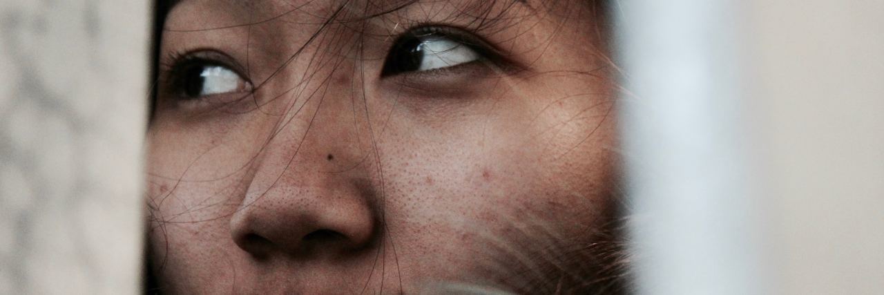 Using the DBT skill 'DEAR MAN' in a Real Situation close up photo of older asian woman looking off to side