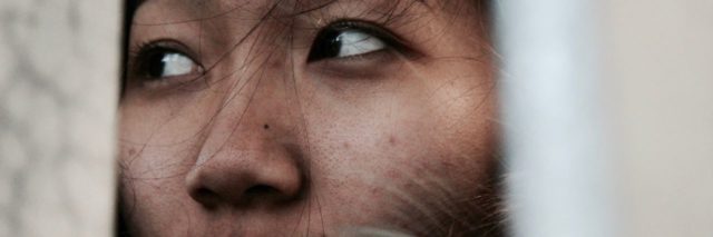 close up photo of older asian woman looking off to side