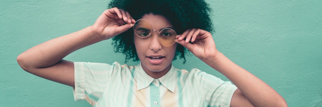 Reminders for People With Bipolar Disorder in Their 20s A woman with glasses, making a goofy face