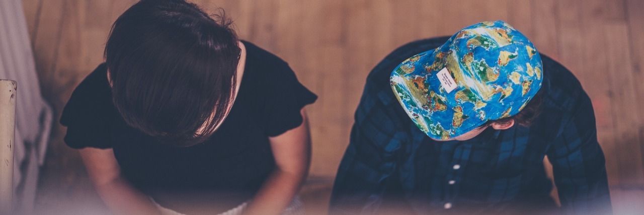 Being True to Yourself to Help With Anxiety two people sitting on porch and talking. one is wearing a blue baseball cap