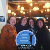 Eileen with three female friends at an apraxia awareness event.