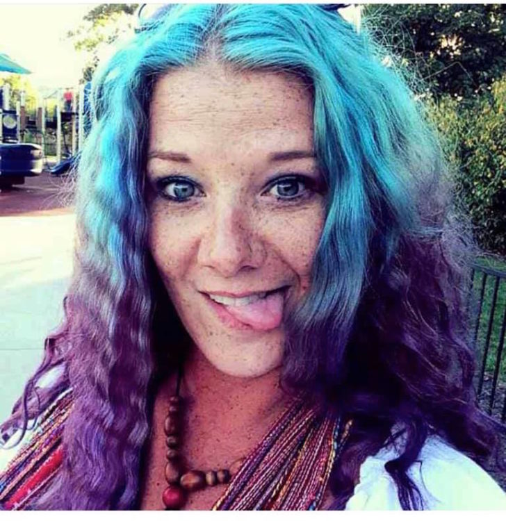 woman with blue and purple hair sticking tongue out