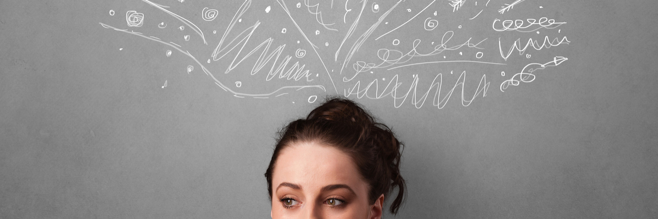 Questioning the Validity of Mental Health Diagnoses A woman against a grey wall, with lines and question marks over her head