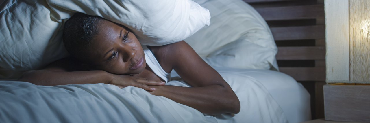 When You're Chronically Ill There's Never Enough Time a woman is laying on her bed