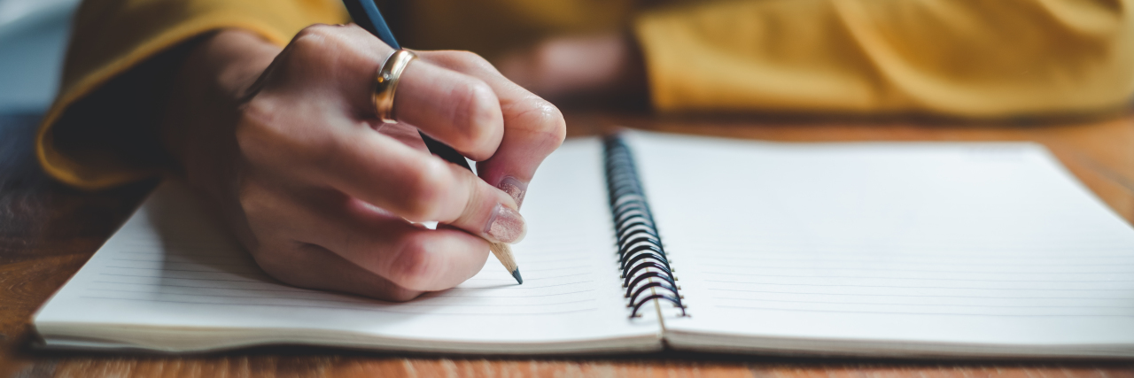 What a Day With Ehlers-Danlos Syndrome Feels Like Close up of woman hand writing on notebook