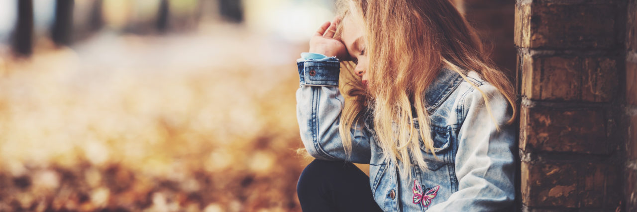 Grieving My Dad's Suicide: What I Wish He'd Told Me Portrait of a little girl squatting on the street