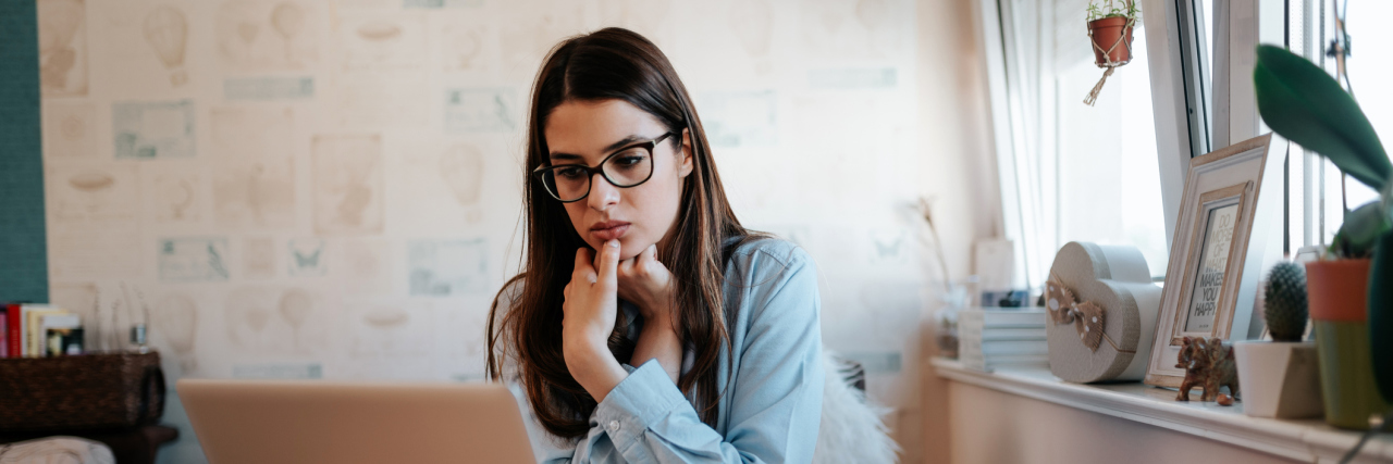 What It Means to Be Undiagnosed Worried girl looking at laptop screen at home.
