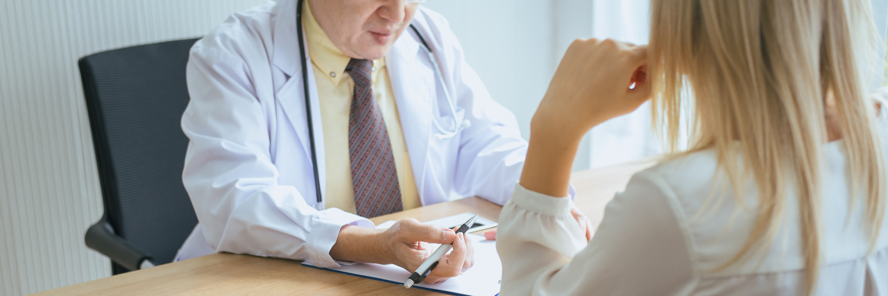 The 'Routine' Question That Held New Meaning After My Hysterectomy a doctor is speaking to a patient seated at a table