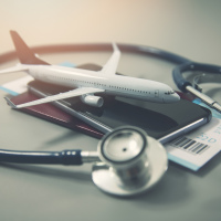 Travel insurance concept, model plane, stethoscope and passport.