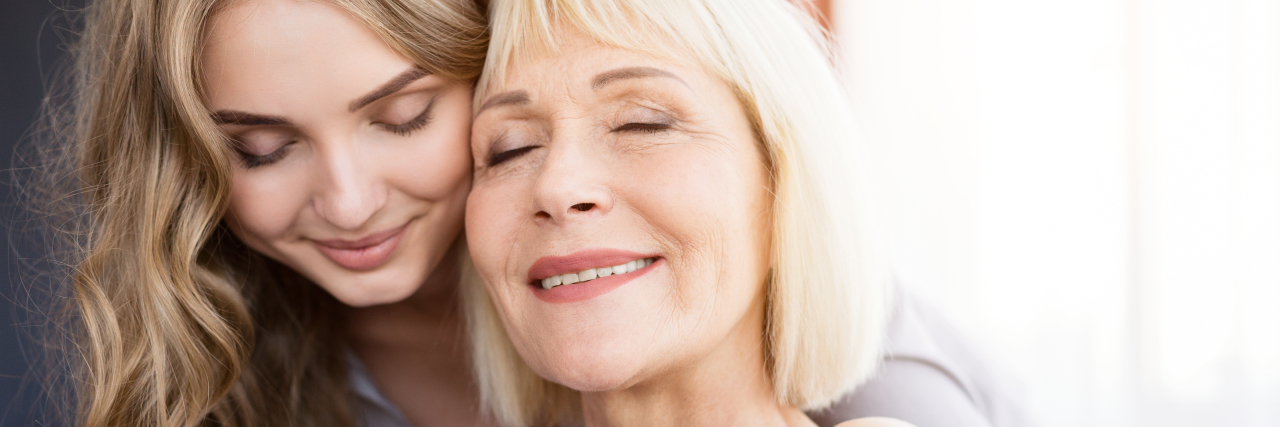 a young daughter and mother embracing