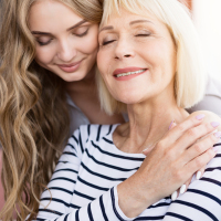 a young daughter and mother embracing