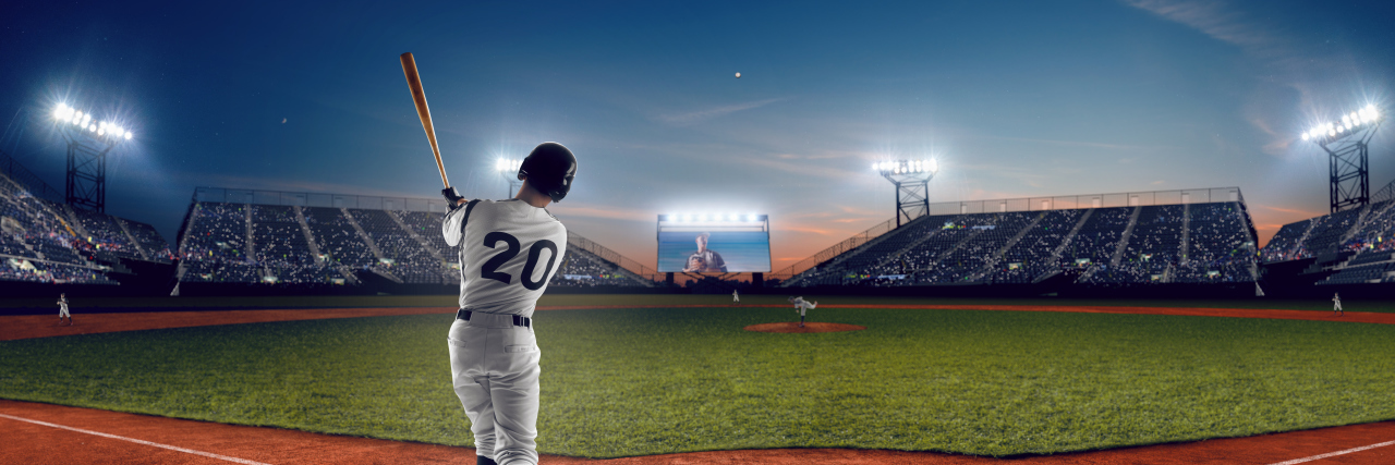 When I Found Out My Life-Changing Injury Could Have Been Prevented Baseball player hitting ball in stadium.