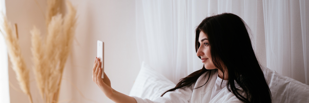 Weirdest Mental Illness Recovery Strategy: Talking to Myself on Video woman recording herself on her phone