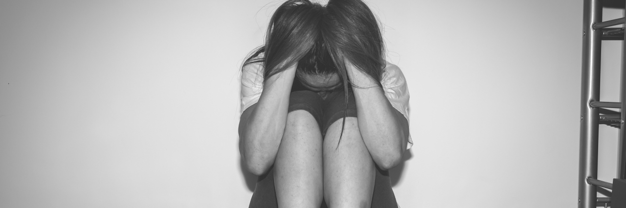 Read This If You Feel Like a Zombie a sad girl sitting alone with her head tucked down